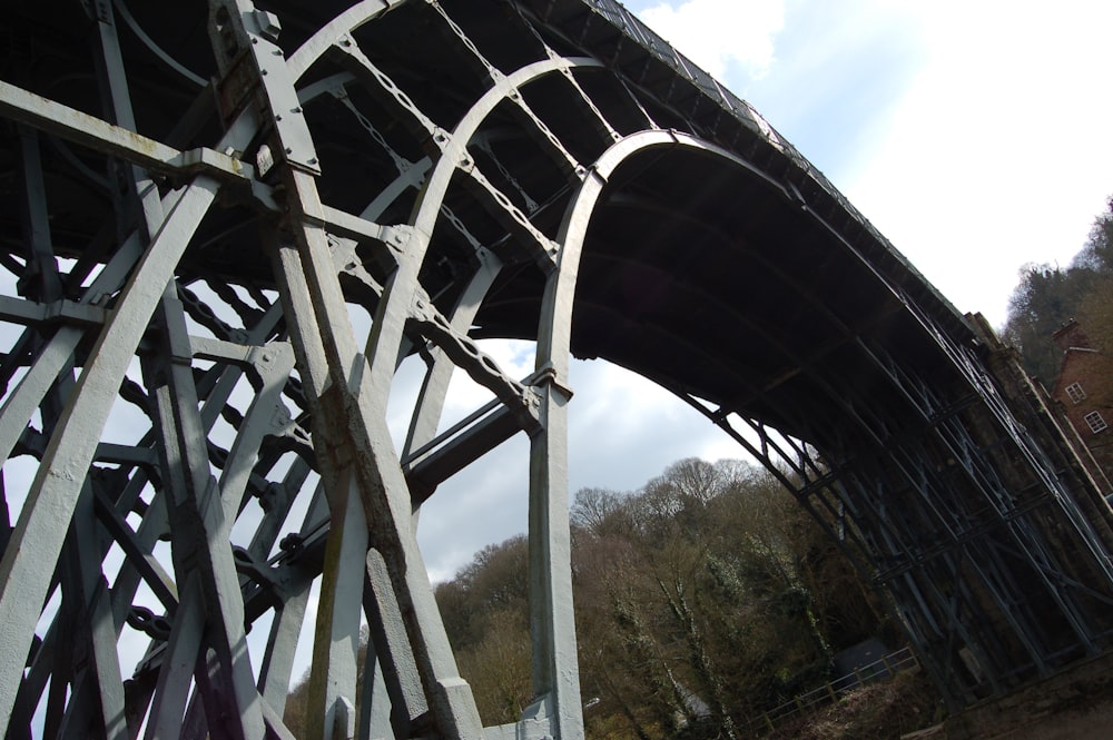 a large metal structure with a clock on top of it