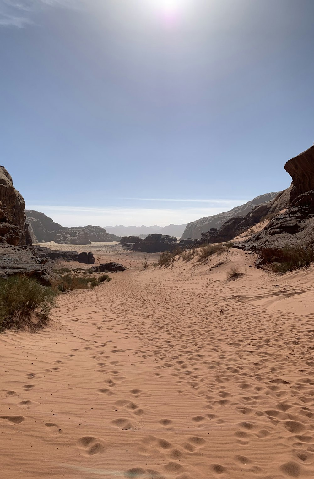 the sun is shining over a sandy area