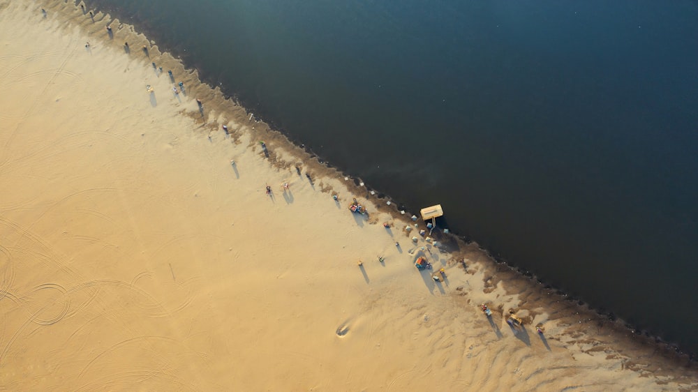 an aerial view of a sandy beach and a body of water