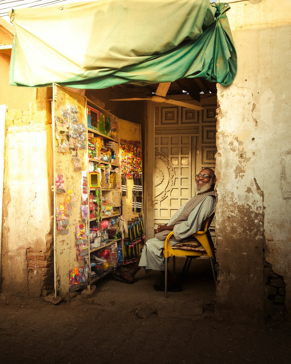 a man sitting in a chair in front of a store