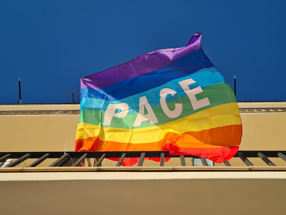 a rainbow flag with the word peace on it