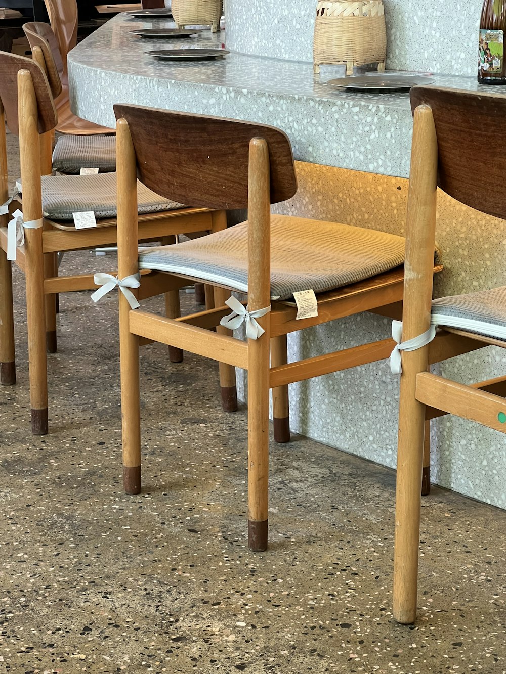 a group of wooden chairs sitting next to each other