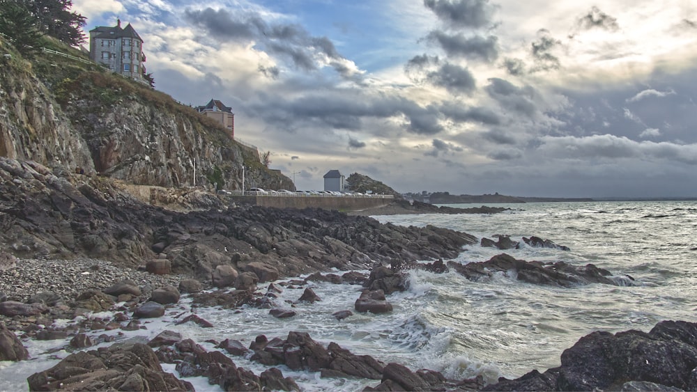 a rocky shore with a lighthouse on top of it