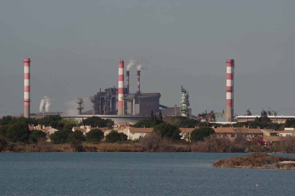 a large factory with smoke stacks rising from it's stacks