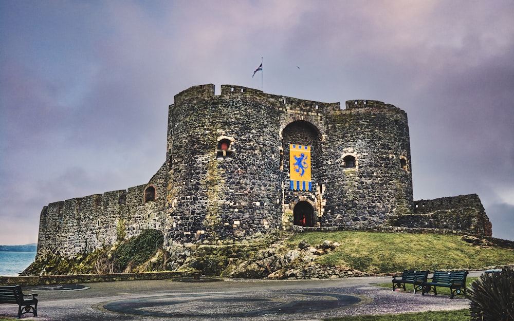 a stone castle with a bench in front of it