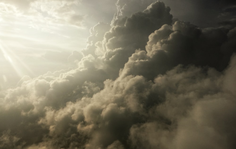 a plane flying in the sky with a lot of clouds