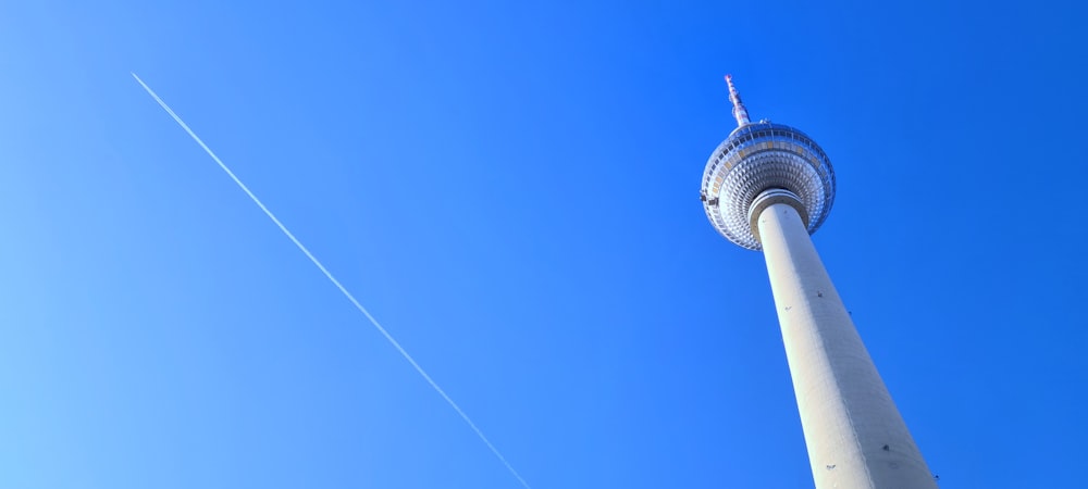 a tall white tower with a sky background