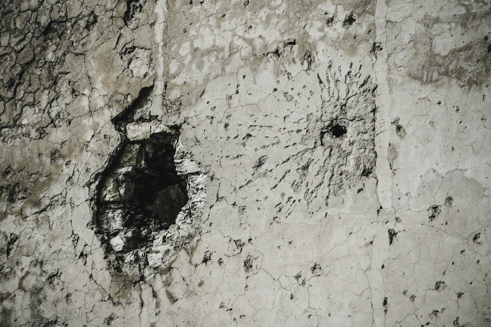 a close up of a wall with a hole in it