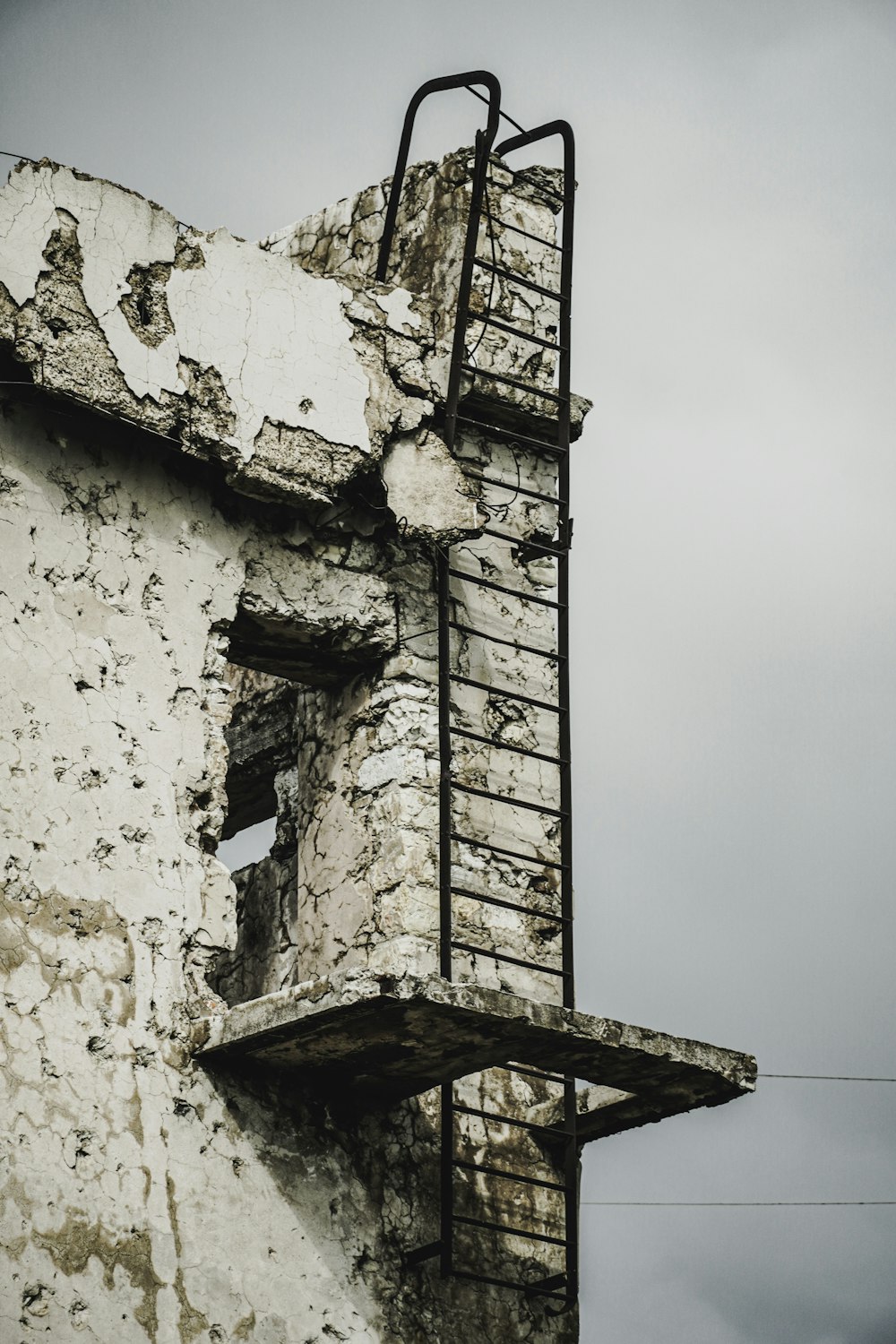 an old building with a ladder on the side of it