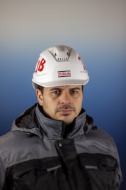 a man wearing a hard hat and jacket