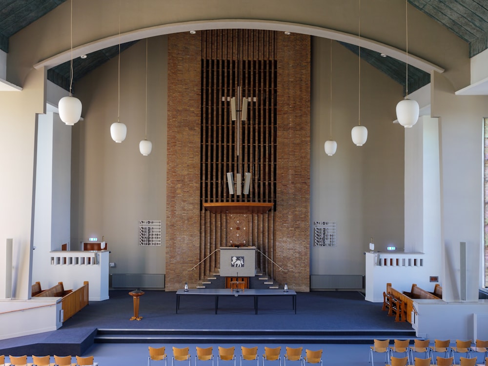 an empty church with a cross on the alter