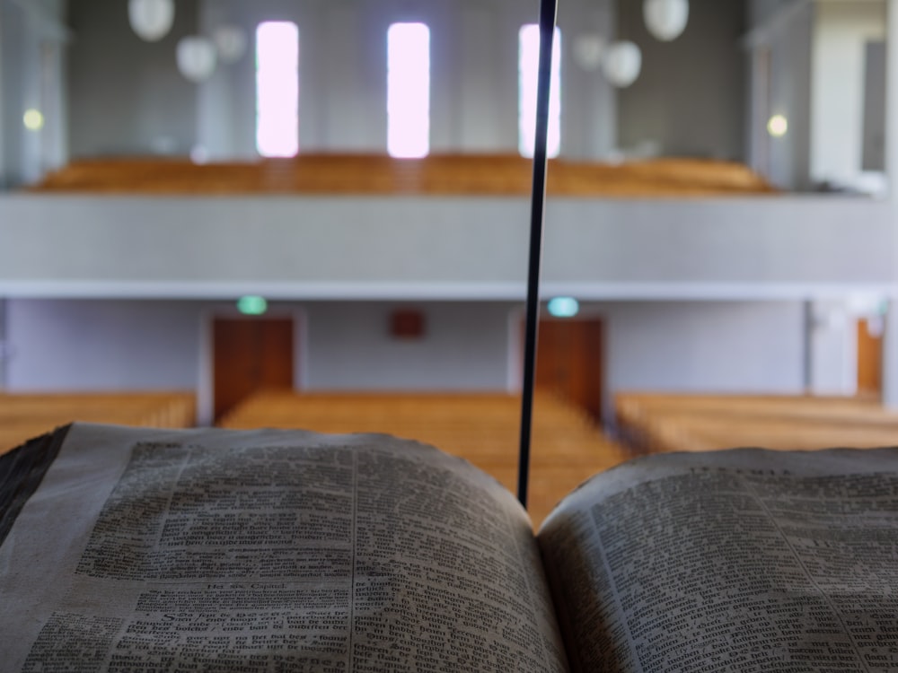 an open book in a church with pews