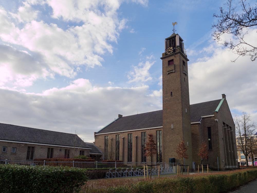 a church with a clock tower on a cloudy day