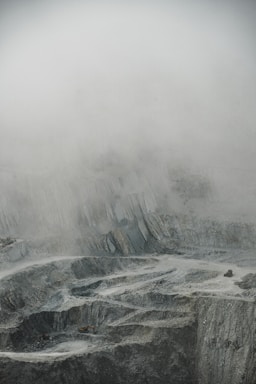 a man standing on top of a snow covered mountain