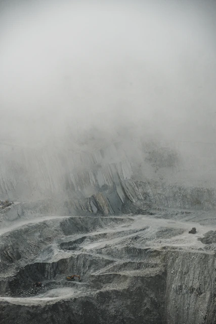 a man standing on top of a snow covered mountain