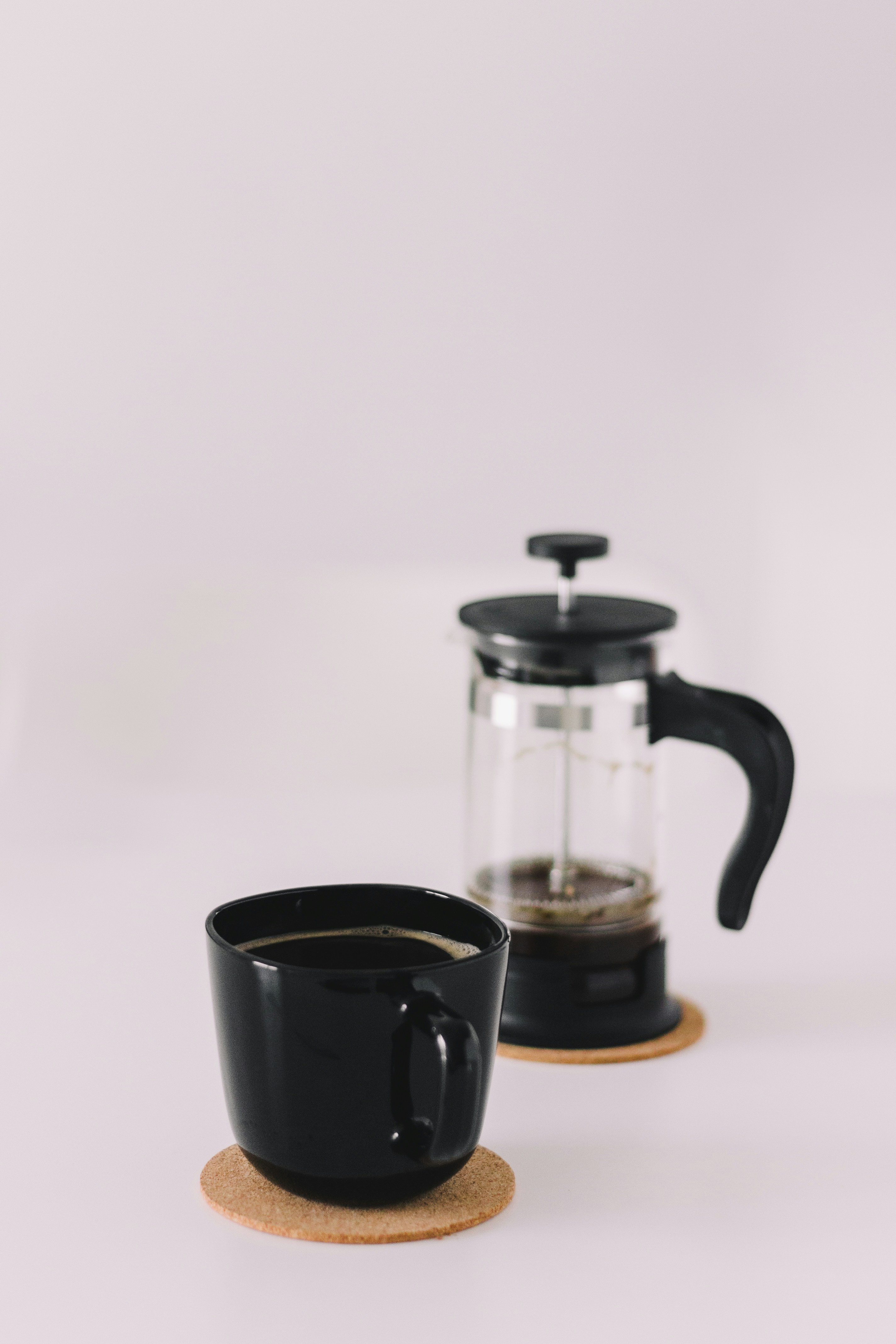 a coffee pot and a coffee cup on a coaster