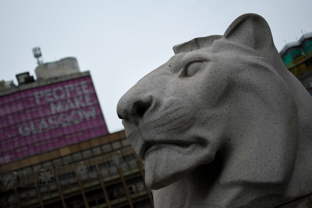 a statue of a cat in front of a building