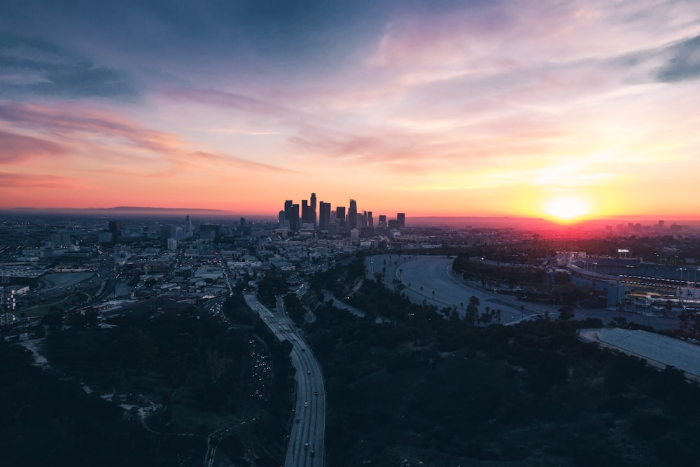 the sun is setting over the city of los angeles
