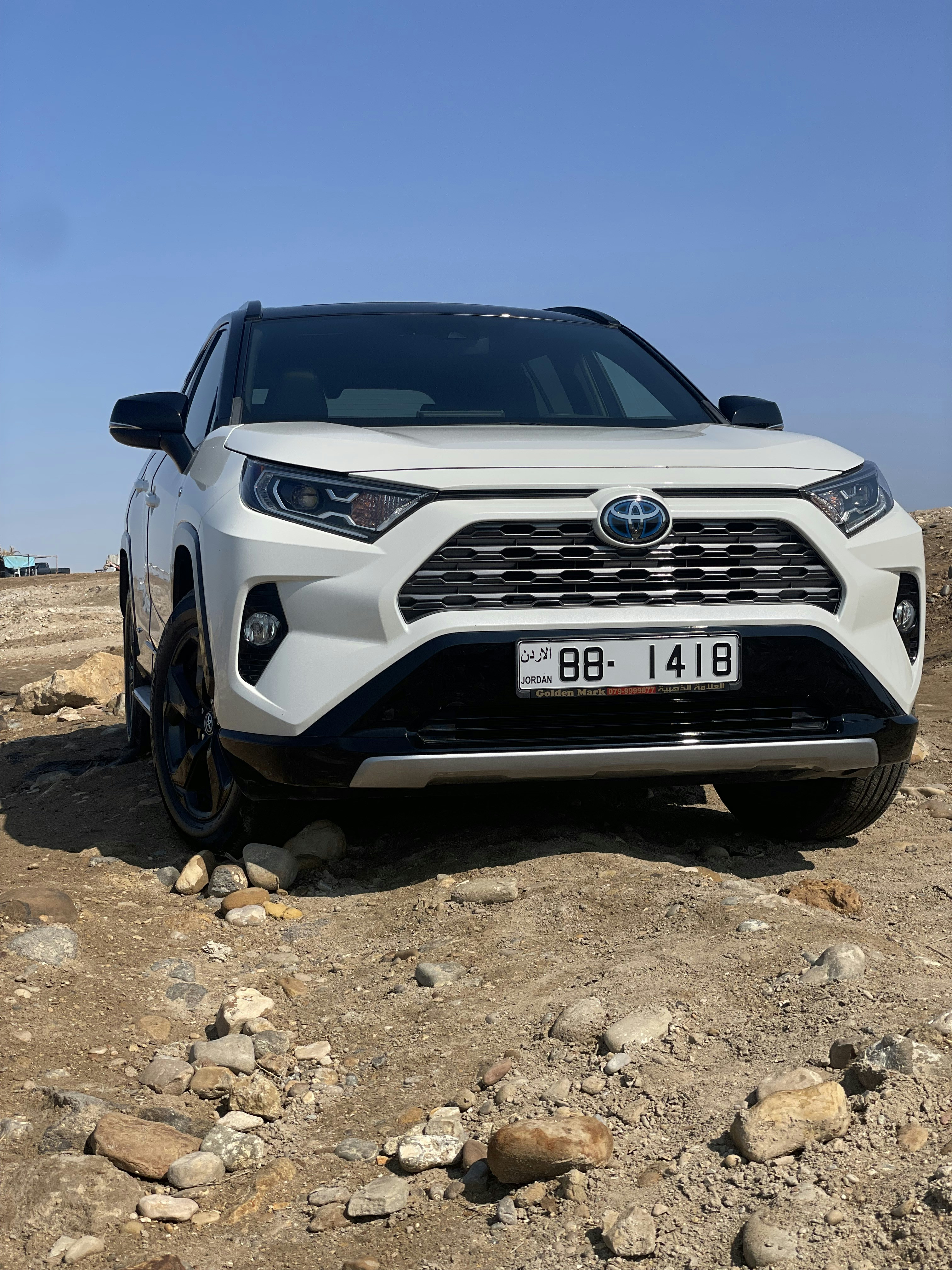 Toyota SUV parked in scenic mountain location, representing the best-selling hybrid SUV in America