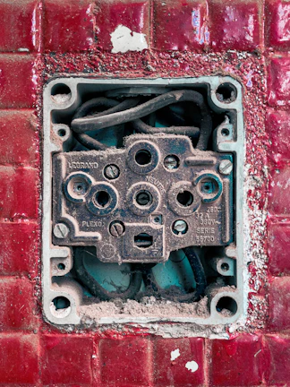 Close-up of hands replacing a burnt electrical socket safely
