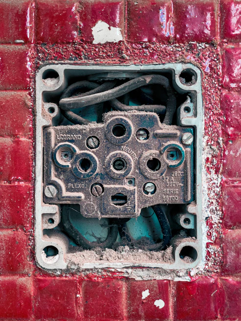 Electrician using a multimeter to test a residential electrical socket