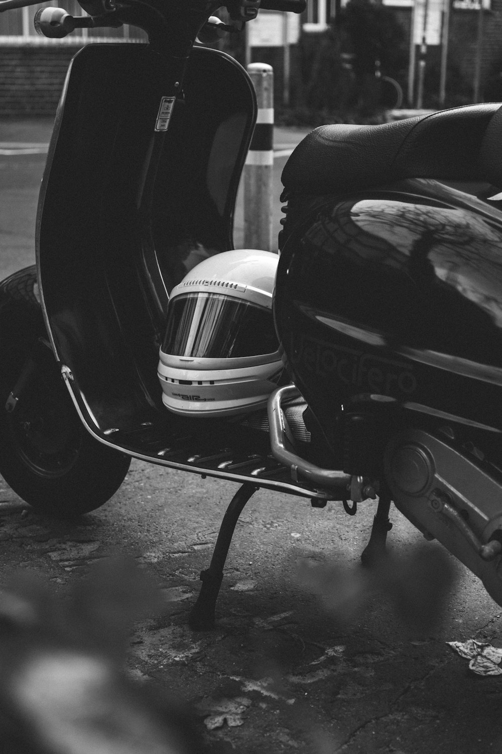 a black and white photo of a motor scooter