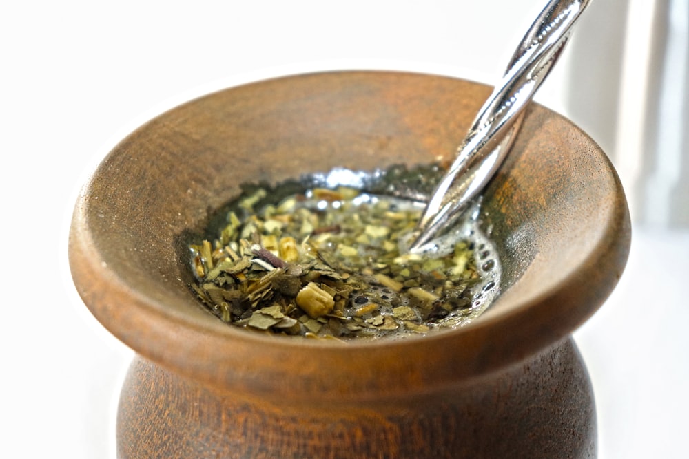 a wooden bowl with a spoon inside of it