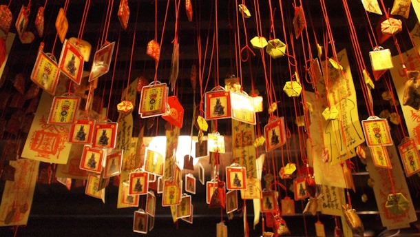 a group of chinese lanterns hanging from strings