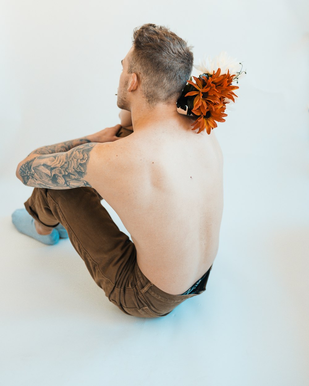 a man with a flower in his hair