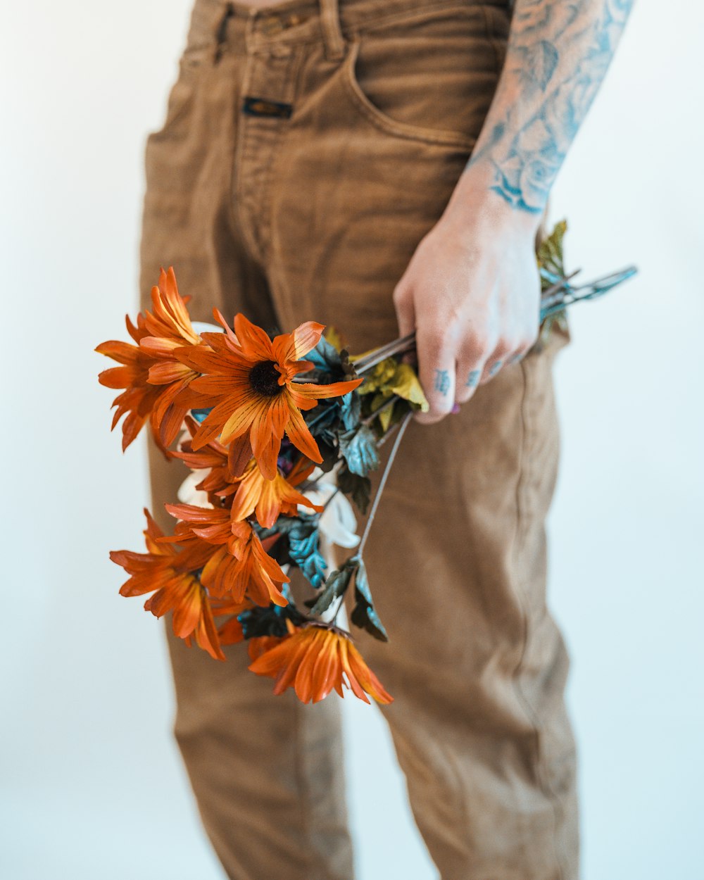 a person holding a bunch of flowers in their hands