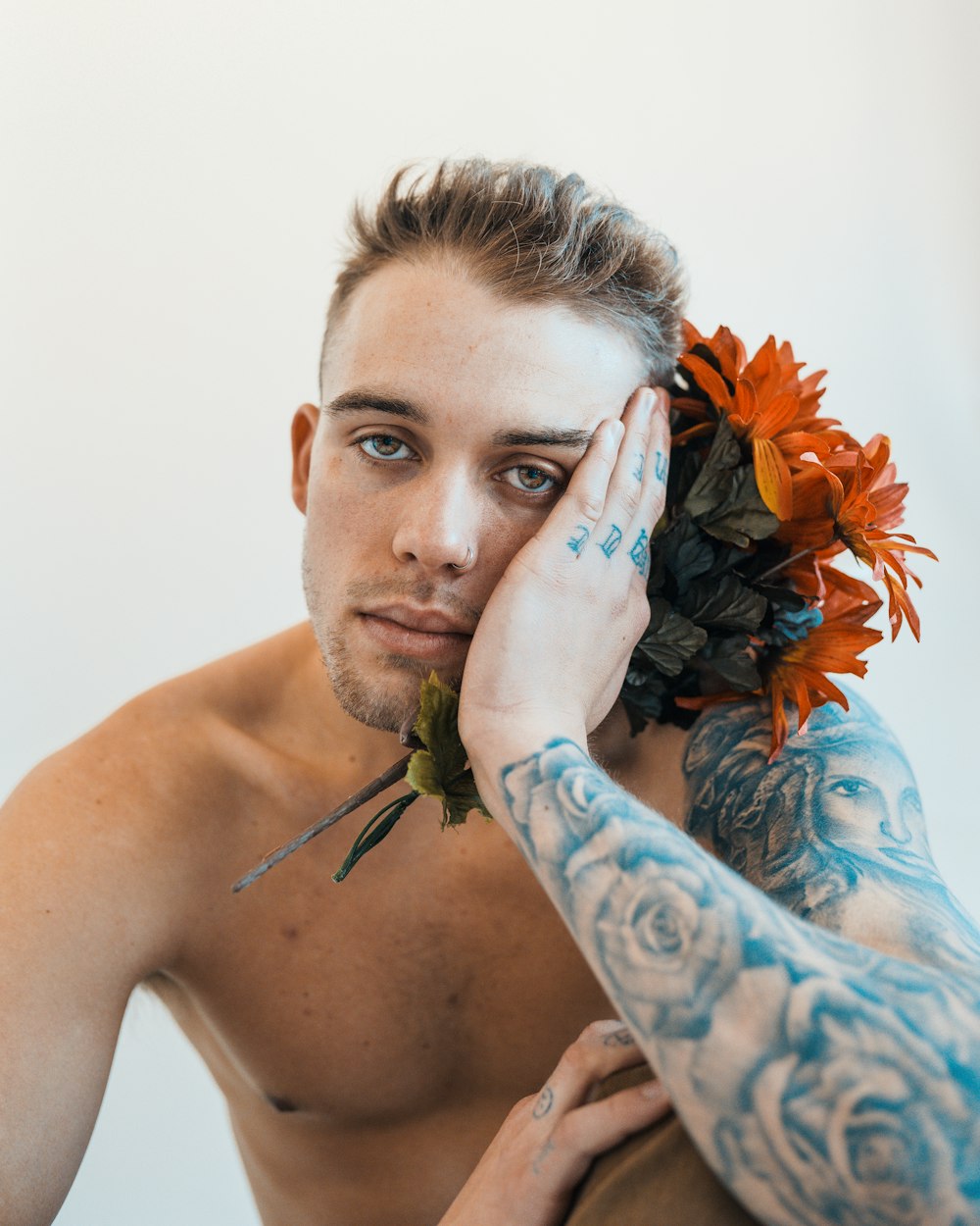 a man with a flower in his hair