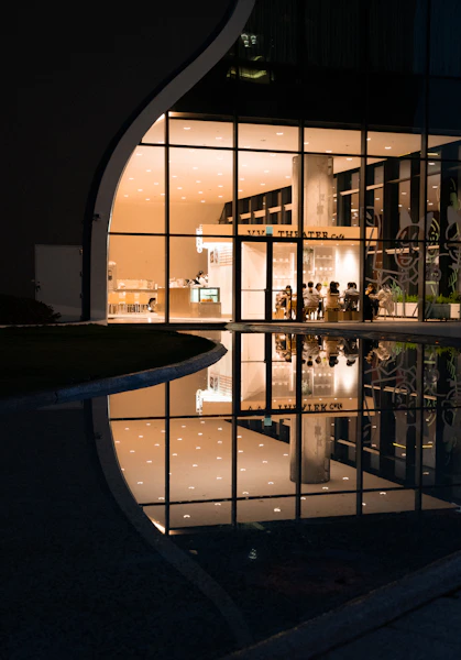 a reflection of a building in a pool of water