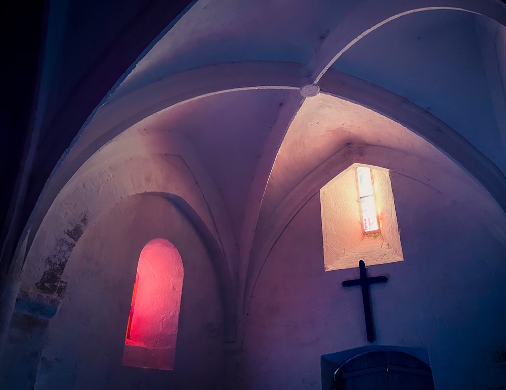 a church with a cross and a lit window