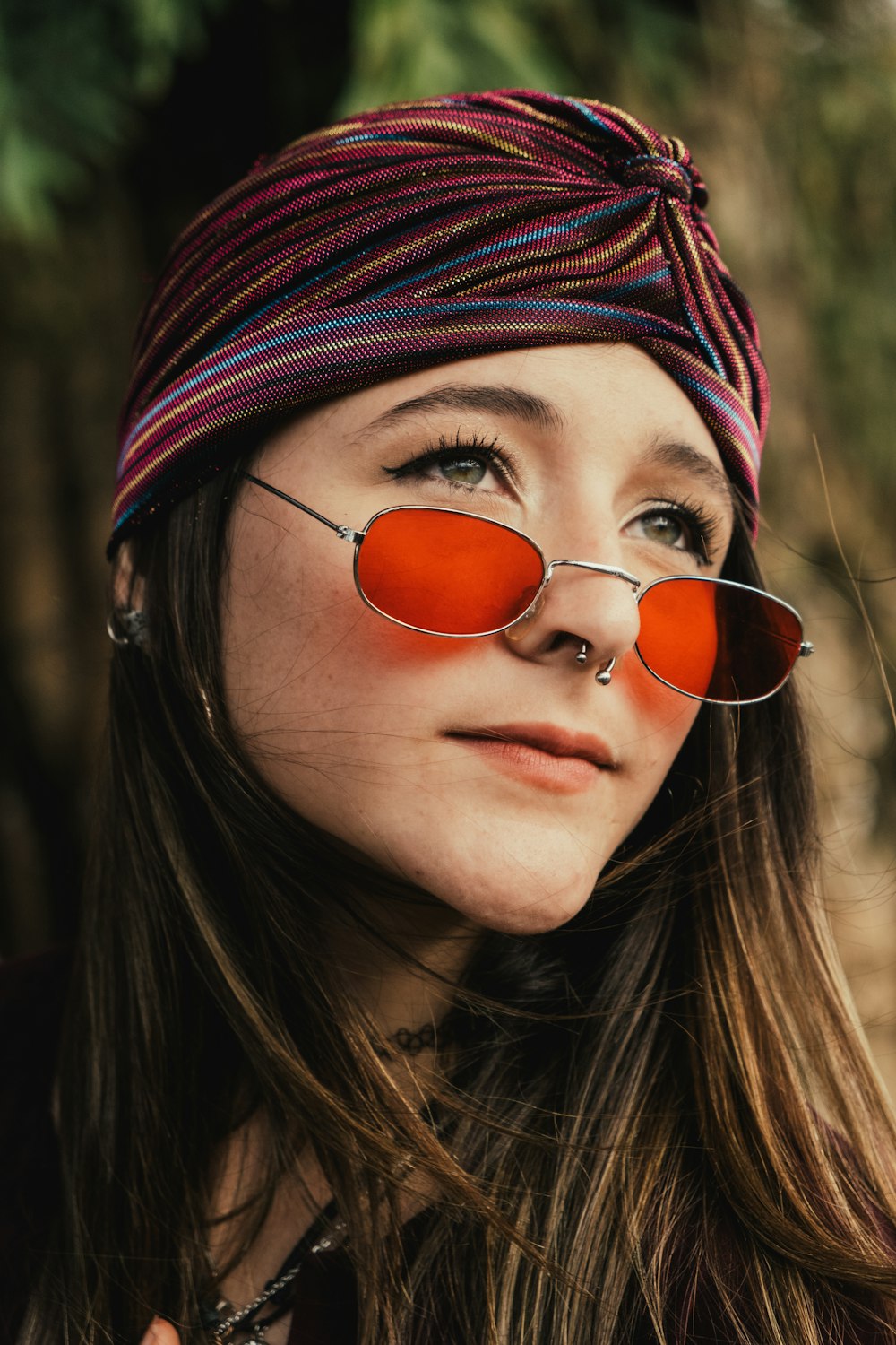 a woman wearing red sunglasses and a headband