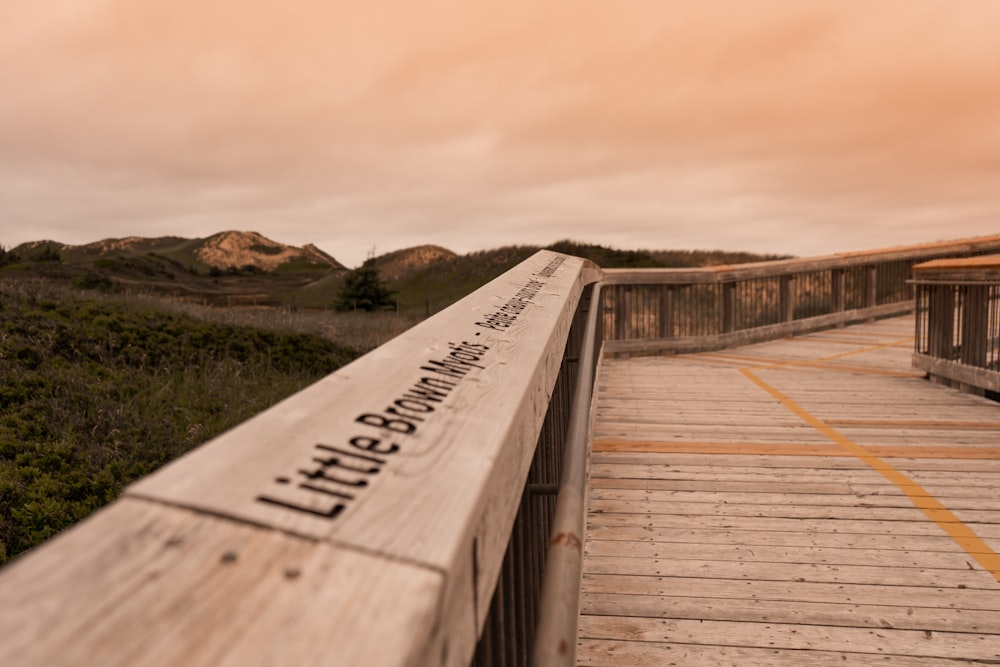 a wooden walkway with a sign on it