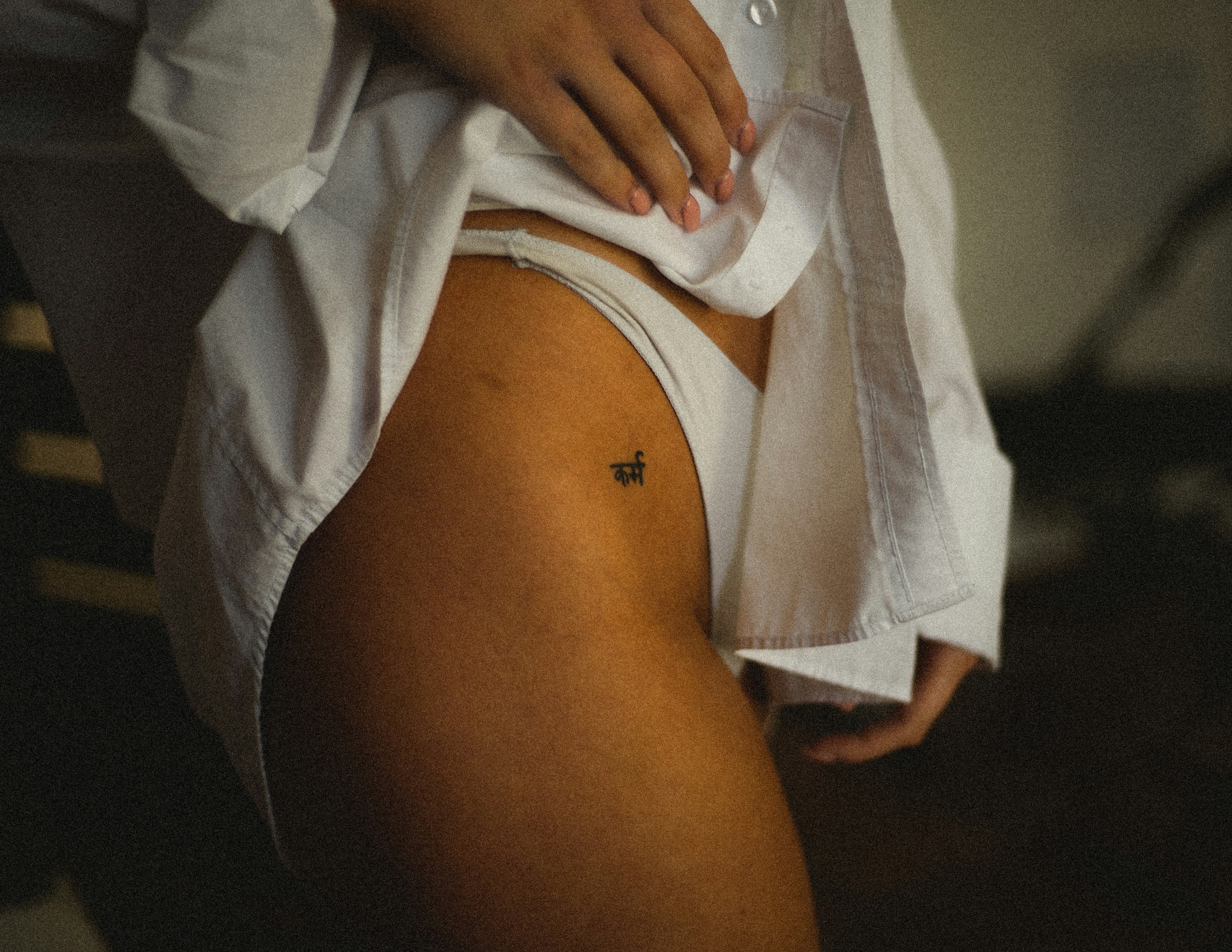 a woman with a small tattoo on her thigh