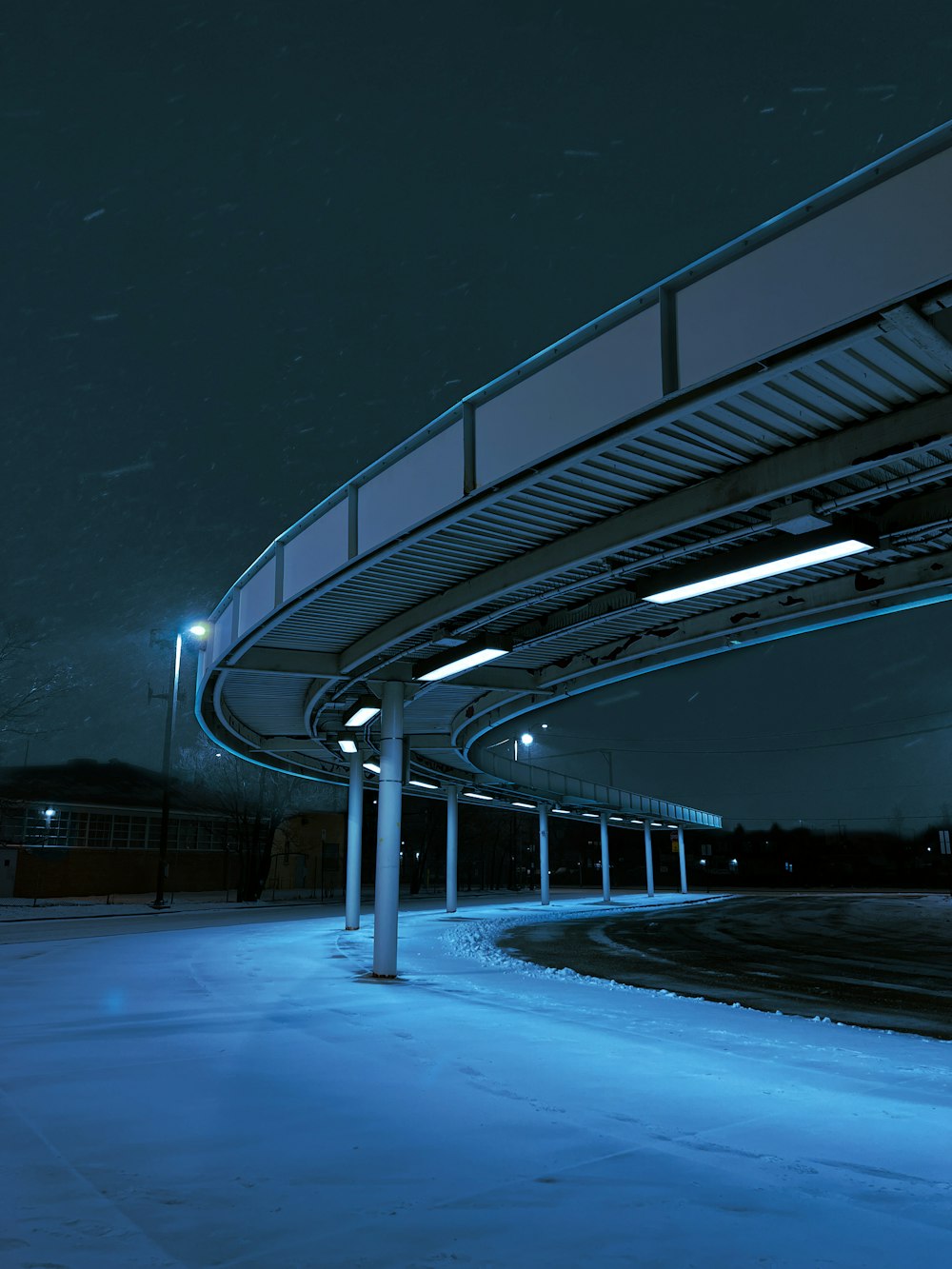 a night time picture of a snow covered parking lot