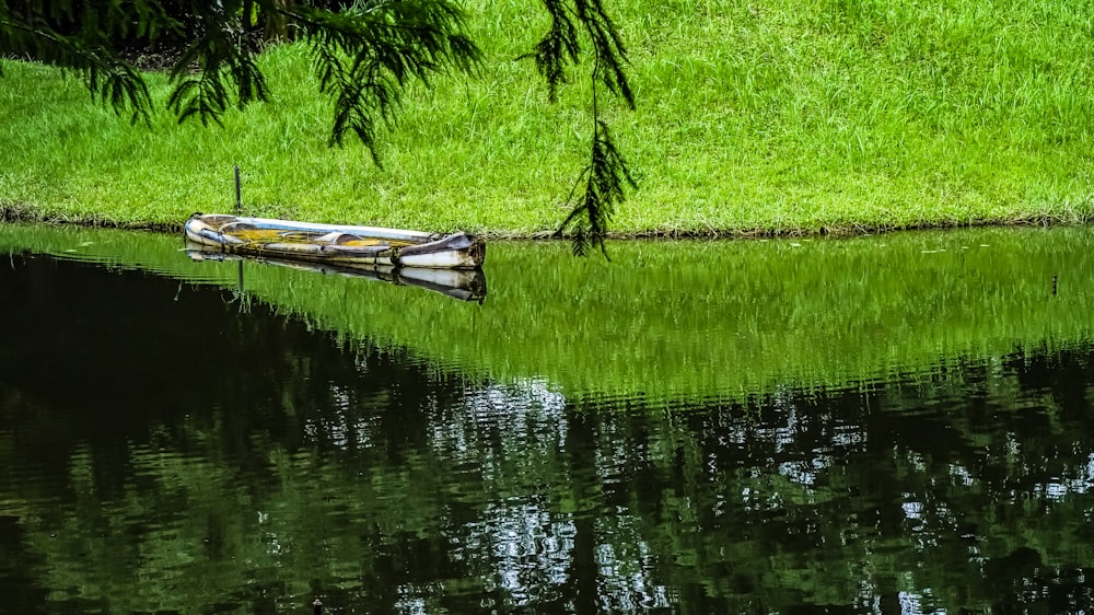 a small boat sitting on top of a body of water
