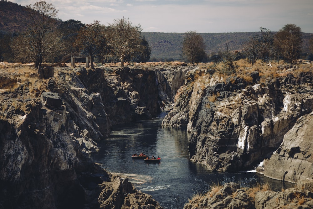 a couple of boats floating on top of a river