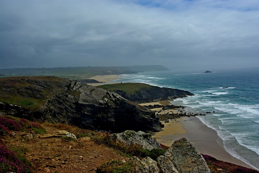 a view of the ocean from a rocky cliff