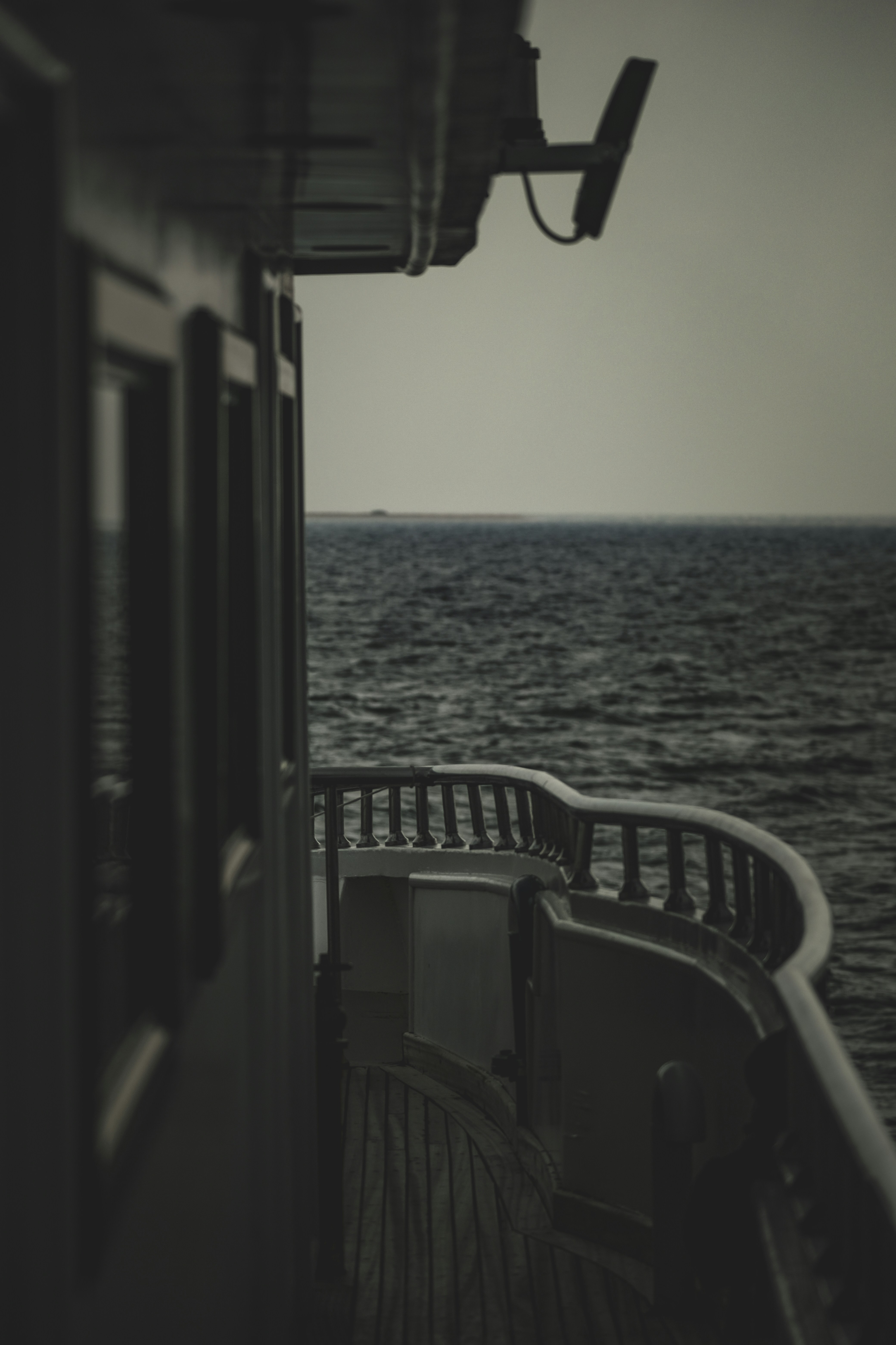 a black and white photo of a boat in the ocean