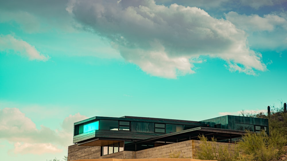 a building on top of a hill with a sky background