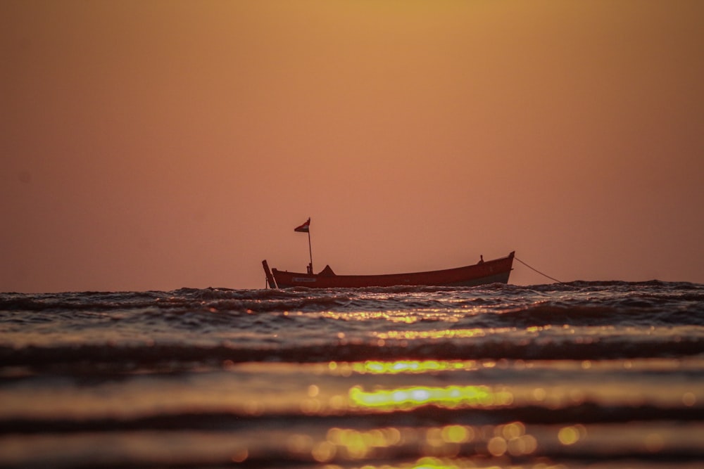 a small boat floating on top of a body of water