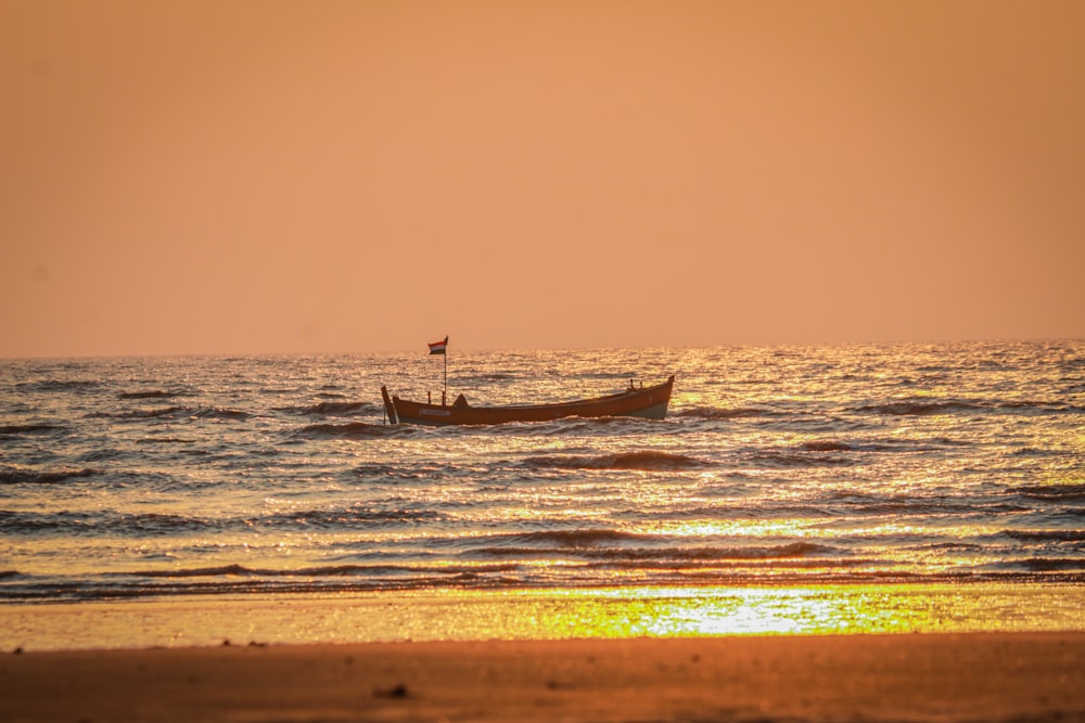 a small boat floating on top of a body of water