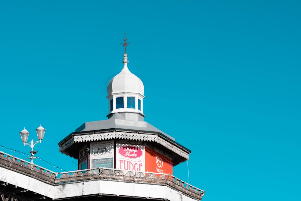 a clock tower on top of a building with a sky background