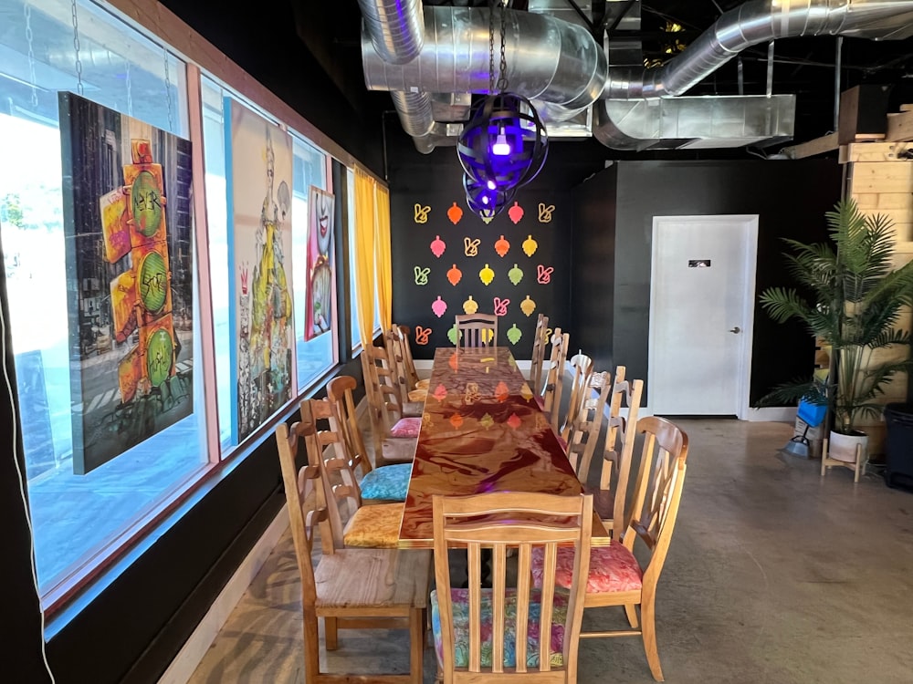 a dining room with a long table and chairs