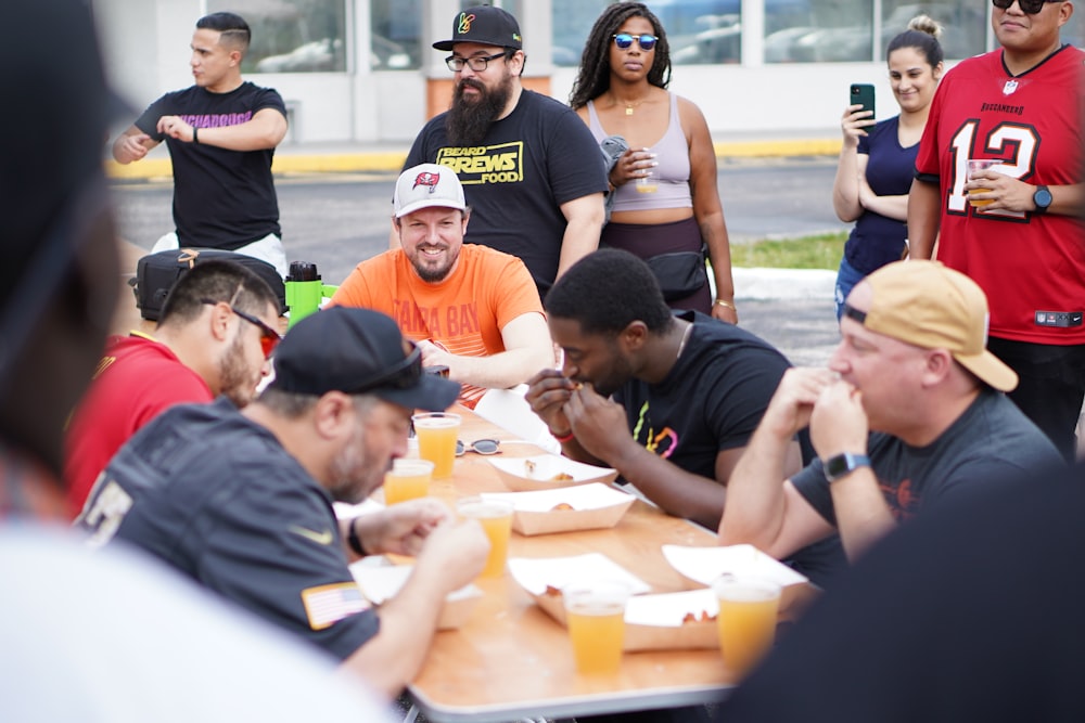 a group of people sitting around a table eating food