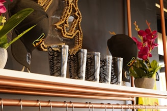 a shelf with a bunch of vases and flowers on it