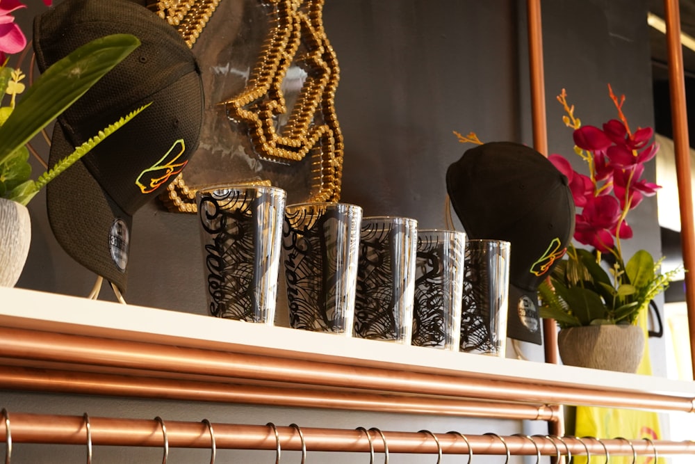 a shelf with a bunch of vases and flowers on it