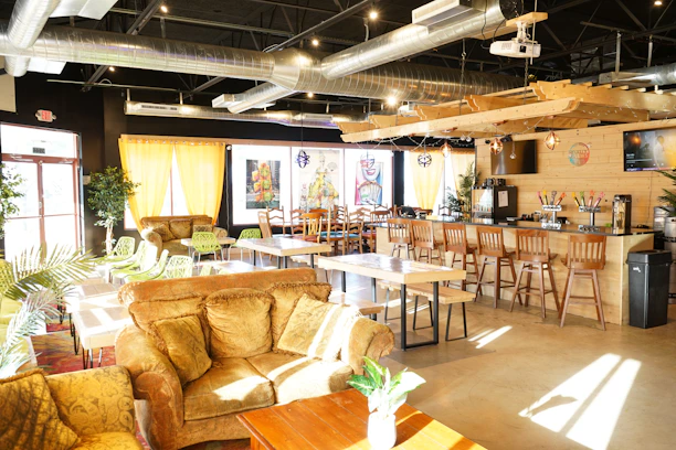 Cozy interior of Brisacafé with warm lighting and comfortable seating.